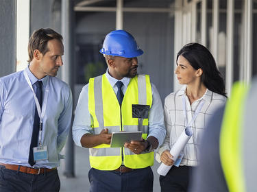 A team member walks visitors through a distribution cente