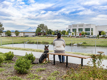 A woman and her dog looking at Tacoma Distribution Center