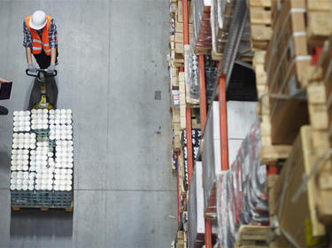 Three workers with a pallet jack in a Prologis warehouse