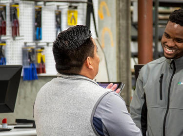 Two Customer Experience Team members talk business