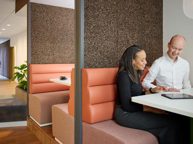 Two people sitting in an open office space